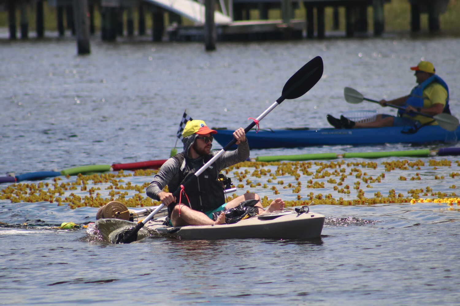 Several kayakers converge to collect the ducks after the race.